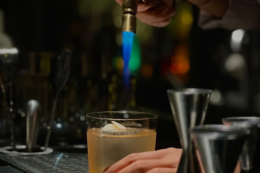 Torch Drink Guide: Hemp Seltzers, Effects, & Flaming Cocktails Flaming Torch Cocktail with Citrus Garnish